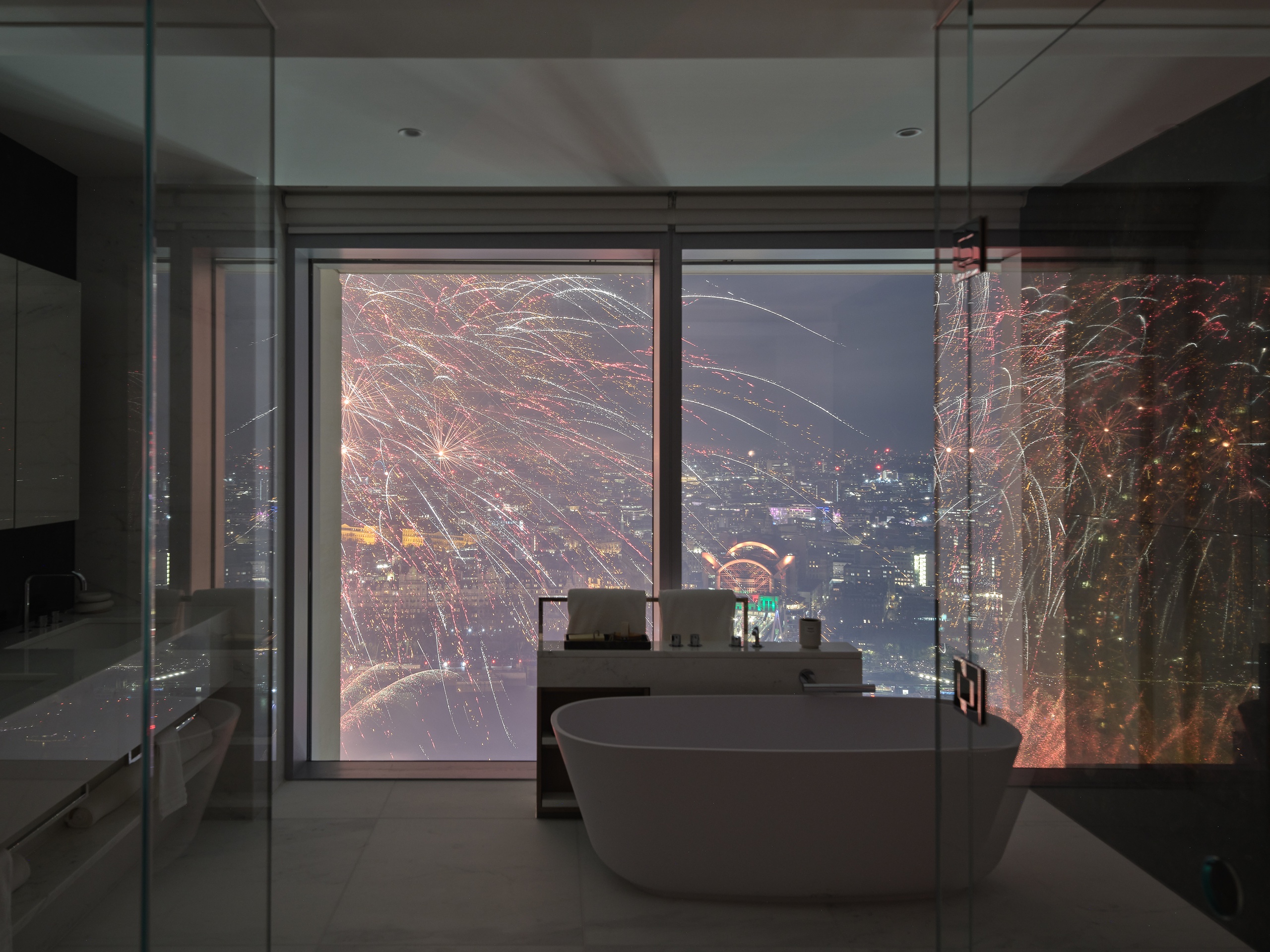 View of London Eye's fireworks from Southbank Place apartment bathroom